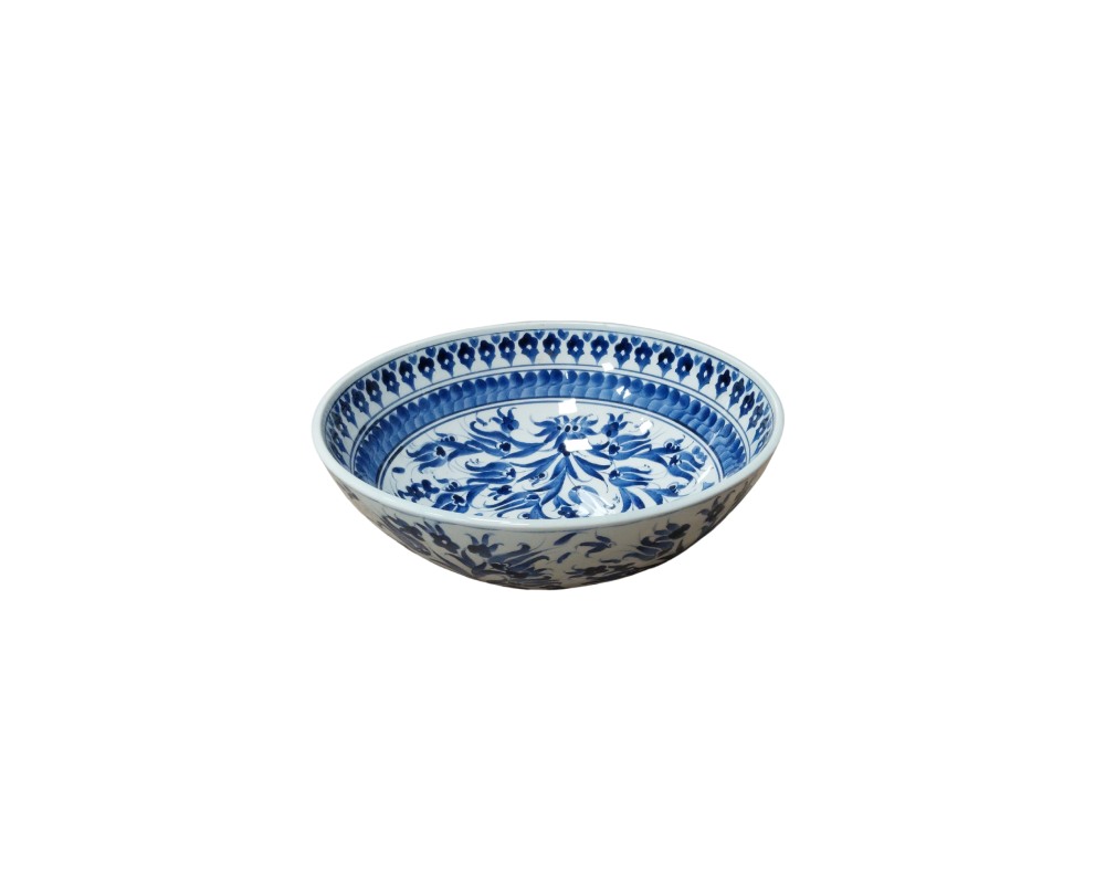 A circular white ceramic vessel, characterised by a classic design adorned with hand-painted floral and ornamental patterns in shades of cobalt blue on both the inside and outside; available for hire for events, advertising, films and TV series