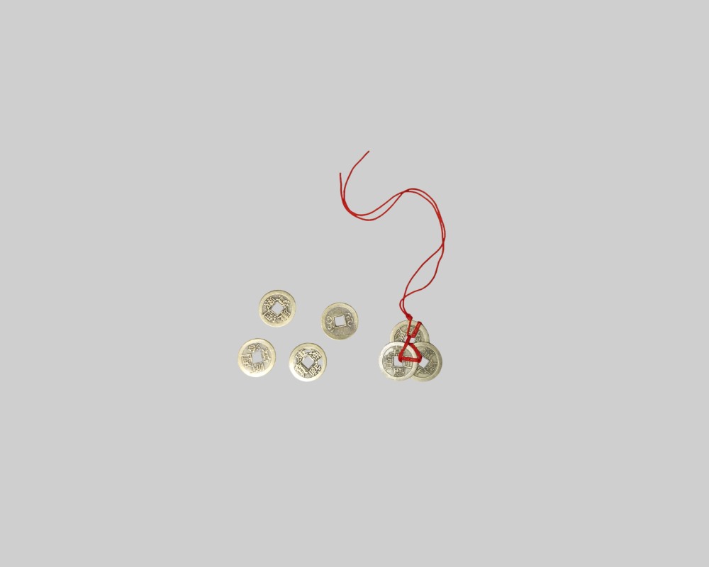 The set includes several traditional, antique-style coins with a square hole in the centre and inscriptions, some of which are strung together on a red thread. Available for hire for events, advertising, films and TV series.