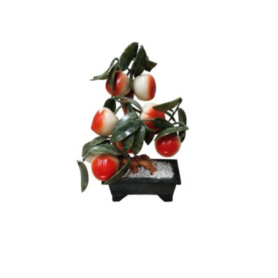 Ornamental bonsai made from minerals or sculpted stones, characterised by a trunk resting on a base that resembles white gravel inside a dark rectangular pot, with green leaves and numerous round fruits in shades ranging from red to white; available for hire for events, advertising, films and TV series