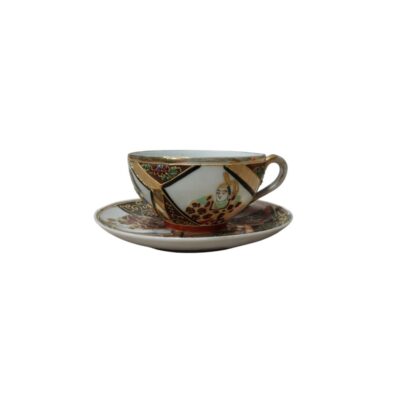 This cup and saucer set features detailed and elegant decoration, characteristic of traditional Oriental-inspired ceramics. The piece stands out for its geometric panel design, accentuated by gold-coloured rims. Hire for events, advertising, films and TV series