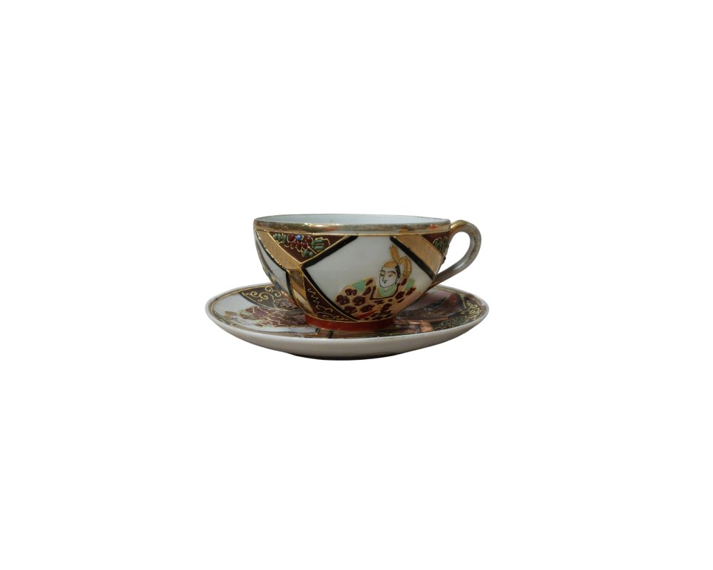 This cup and saucer set features detailed and elegant decoration, characteristic of traditional Oriental-inspired ceramics. The piece stands out for its geometric panel design, accentuated by gold-coloured rims. Hire for events, advertising, films and TV series