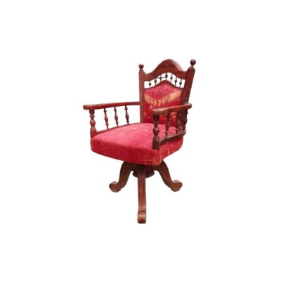 This handcrafted-style swivel chair is made from teak and features red upholstery with traditional Phulkari motifs from Punjab. Available for hire for events, advertising, films and TV series.