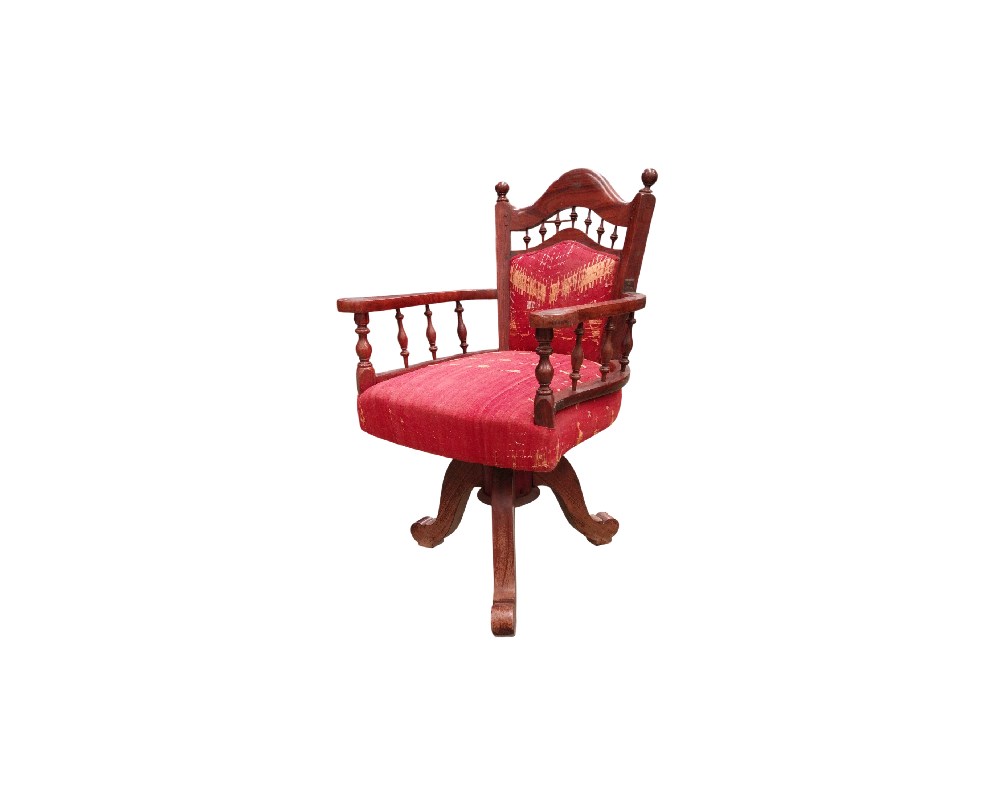 This handcrafted-style swivel chair is made from teak and features red upholstery with traditional Phulkari motifs from Punjab. Available for hire for events, advertising, films and TV series.
