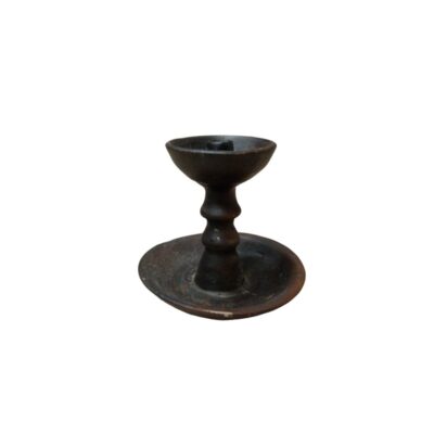 Wooden candle holder with a polished finish in dark tones, comprising a wide, concave circular base that acts as a drip tray, a central turned shaft with mouldings, and a small upper cup to hold the candle available for hire for events, advertising, films and TV series