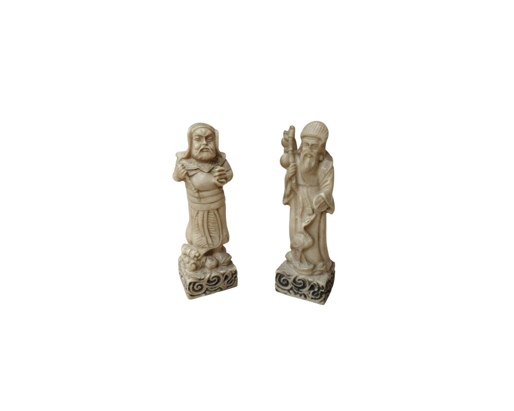 Two figurines carved from a material that mimics the appearance of ivory. They depict traditional figures from Eastern iconography, with meticulous detail in their clothing, facial expressions and accessories; available for hire for events, advertising, films and TV series