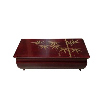 A wooden box with an elegant dark-toned lacquer finish, decorated on the top lid with a subtle gold bamboo motif. When opened, it reveals an internal musical mechanism alongside a compartment lined with red velvet, as well as a mirror integrated into the inside of the lid. It is a handcrafted piece that combines mechanical functionality with ornamental aesthetics, ideal as a collector’s item or decorative gift.