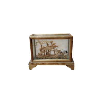 A small rectangular display case housing a delicate, handcrafted diorama, made primarily from carved cork. The scene recreates a traditional oriental landscape featuring a pavilion, stylised trees and bird figures, protected by glass panels and a wooden frame. It is a decorative piece of great detail and craftsmanship, designed to be displayed as a collector’s item that captures a natural scene in miniature. Available for hire for events, advertising, films and TV series.