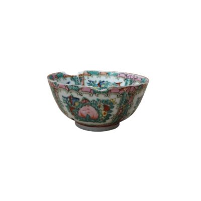 This porcelain bowl features rich, detailed decoration with floral and botanical motifs in vibrant shades of pink, green and other colours, in a traditional artistic style. The piece boasts a sophisticated ornamental design around its body and rim. Available for hire for events, advertising, films and TV series.