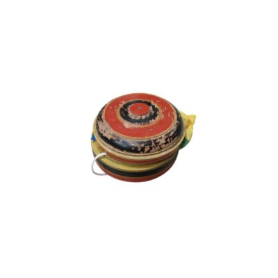 A circular, compact wooden object with a hand-painted finish in shades of red, black and yellow, showing significant signs of wear and tear; available for hire for events, advertising, films and TV series