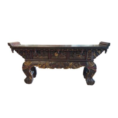 An altar table in a traditional Oriental style with dark finishes, characterised by a rectangular top with raised edges, front panels featuring intricate carved and gilded reliefs depicting figures or scenes, and sturdy, ornate legs; available for hire for events, advertising, films and TV series