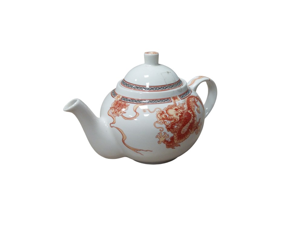 A white porcelain teapot with a classic, refined design. It features delicate decoration in reddish tones depicting a traditional dragon, complemented by geometric details along the upper rim. Available for hire for events, advertising, films and TV series.