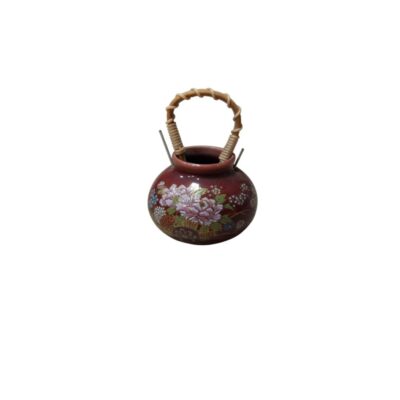 A ceramic vase with a globular body and a dark reddish finish, decorated on the front with a delicate polychrome floral arrangement featuring gold detailing; available for hire for events, advertising, films and TV series