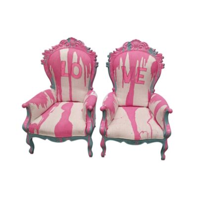 A pair of French Baroque armchairs in the Louis XV style, finished in pink and turquoise paint with ‘LOVE’ graffiti details on the upholstery, available for hire for events, advertising, films and TV series