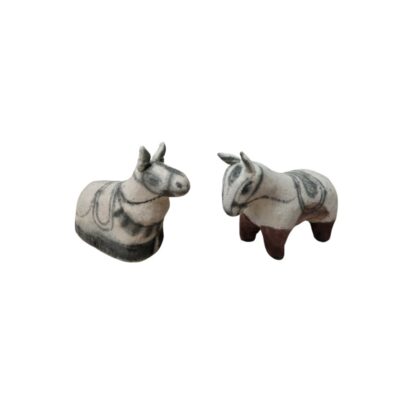 It consists of two small sculptural figures depicting pack animals or horses in stylised forms, crafted in light colours with details painted in dark lines to resemble harnesses and saddles, as well as bases or limbs in earthy tones; available for hire for events, advertising, films and TV series