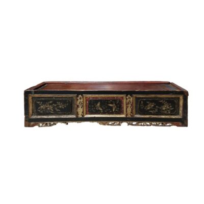 A low-profile rectangular wooden stand, characterised by an aged finish in dark, reddish tones, front panels decorated with delicate floral and bird illustrations in golden tones, framed by mouldings and a lower skirt featuring fine openwork carvings; available for hire for events, advertising, films and TV series