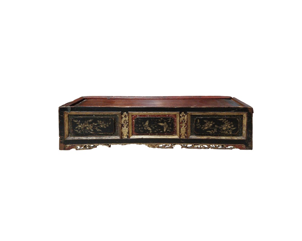 A low-profile rectangular wooden stand, characterised by an aged finish in dark, reddish tones, front panels decorated with delicate floral and bird illustrations in golden tones, framed by mouldings and a lower skirt featuring fine openwork carvings; available for hire for events, advertising, films and TV series