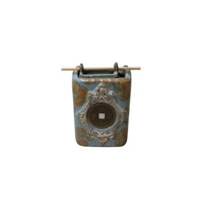 A ceramic container with a glazed finish in shades of blue and brown. It is notable for having a replica of an ancient Chinese coin inlaid on its front, surrounded by an ornamental relief. Hire for events, advertising, films and TV series