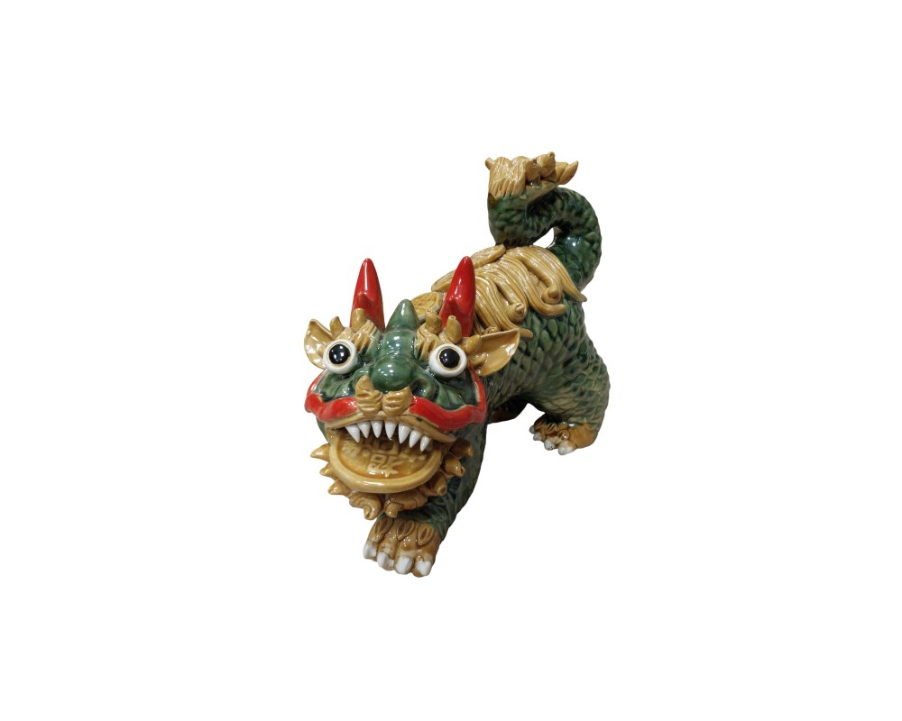 A glazed ceramic figurine depicting a Qilin, a mythical creature from Eastern mythology. The figurine stands out for its colourful finish in shades of green and ochre, with red detailing on the face and horns. Available for hire for events, advertising, films and TV series.