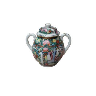 Porcelain sugar bowl with lid, decorated in the traditional ‘Rose Medallion’ style. The piece has a rounded shape with two stylised side handles that mimic the texture of bamboo. Available for hire for events, advertising, films and TV series.