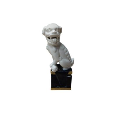 A ceramic figurine depicting a guardian lion, commonly known as a ‘Foo Dog’. The gleaming white figurine shows the lion with its mouth open and tongue sticking out, in a classic watchful pose. Available for hire for events, advertising, films and TV series.