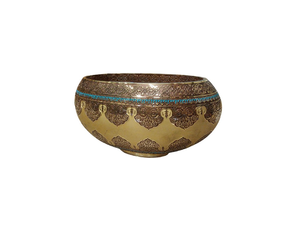A brass or bronze bowl featuring intricate hand-engraved designs, reminiscent of 19th-century Persian or Syrian artistic styles; available for hire for events, advertising, films and TV series