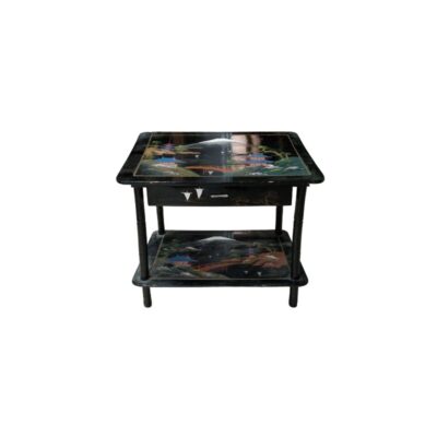 a wooden side table with a glossy black finish, characterised by a two-tiered design with tabletops decorated with detailed oriental landscape scenes — including pagodas, bridges and a snow-capped mountain resembling Mount Fuji —, as well as a front drawer with mother-of-pearl inlays and slender supporting legs. Available for hire for events, advertising, films and TV series.