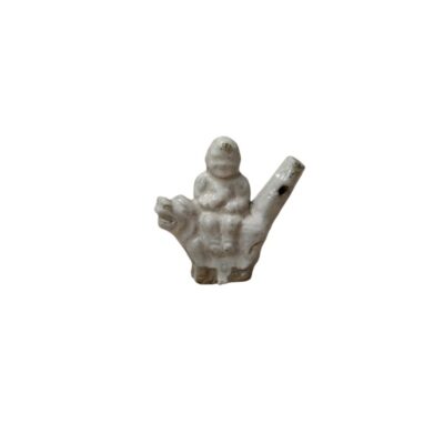 A small white-glazed ceramic statuette depicting a figure seated on the back of an animal, possibly a guardian lion or another mythical creature; available for hire for events, advertising, films and TV series