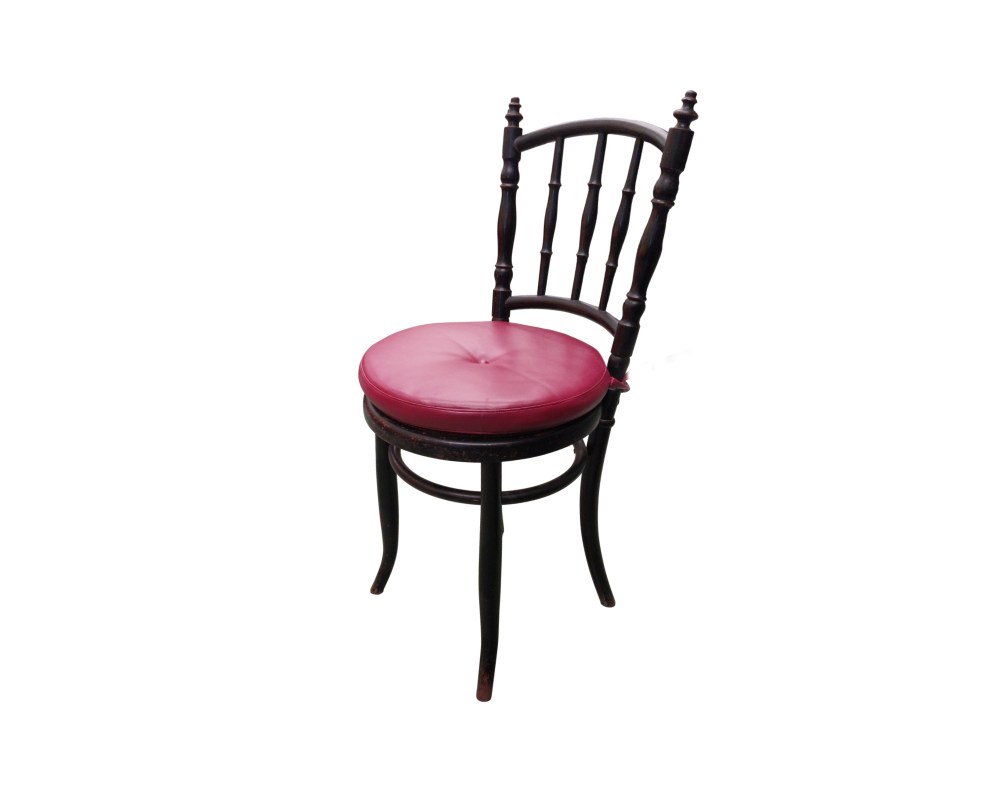 This vintage Thonet-style chair is made from bentwood and features a striking round seat upholstered in red leather; available for hire for events, advertising, films and TV series