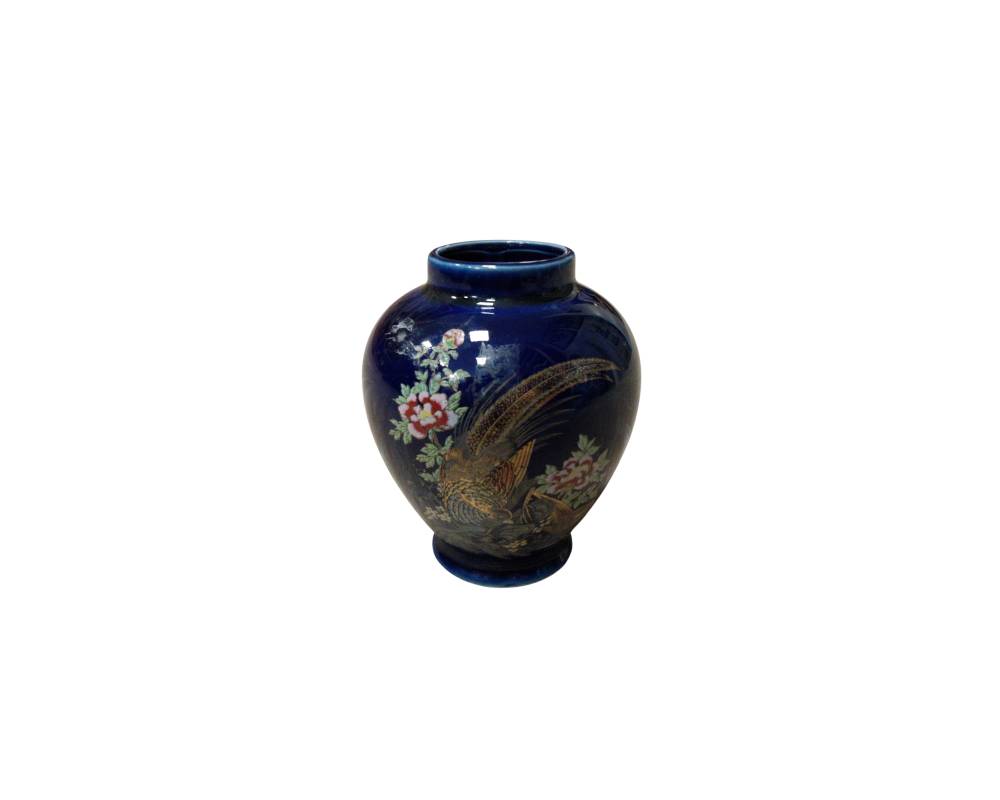 Ceramic vase with a rounded body, short neck and stable base, with a glossy finish in a deep, dark blue shade; available for hire for events, advertising, films and TV series