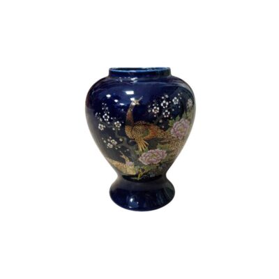 A ceramic vase with a rounded body and a flared base, offering a stable design, with a glossy finish in a deep, dark blue shade; available for hire for events, advertising, films and TV series