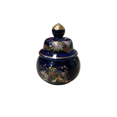 A ceramic sweet dish with a spherical body and a glossy finish in a deep dark blue shade, featuring a stepped lid with a gold-coloured knob at the top; available for hire for props, advertising, films and TV series