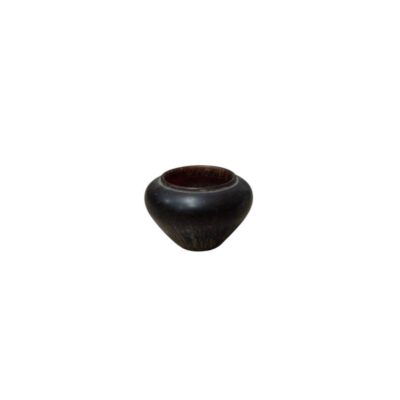 A small bowl with a minimalist design and a rounded shape, characterised by a finish in dark and brown tones with subtle natural veins or textures; available for hire for events, advertising, films and TV series