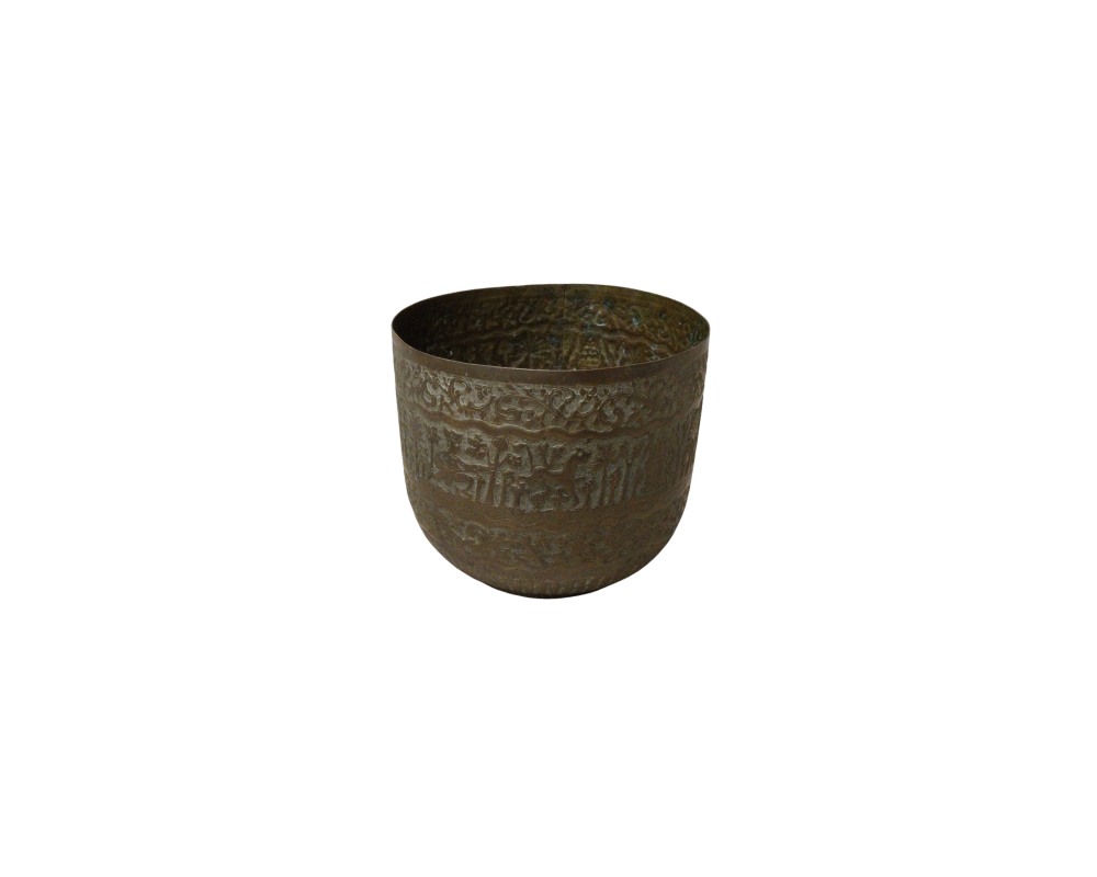 A cylindrical metal bowl with an aged patina, characterised by a surface entirely decorated with bands of chiselled reliefs depicting classical figures and ornamental motifs; available for hire for events, advertising, films and TV series