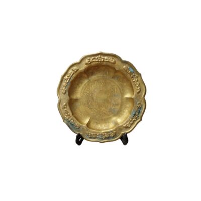 A gold-finished metal plate, characterised by a wavy outer profile and a rim decorated with prominent floral reliefs; available for hire for events, advertising, films and TV series