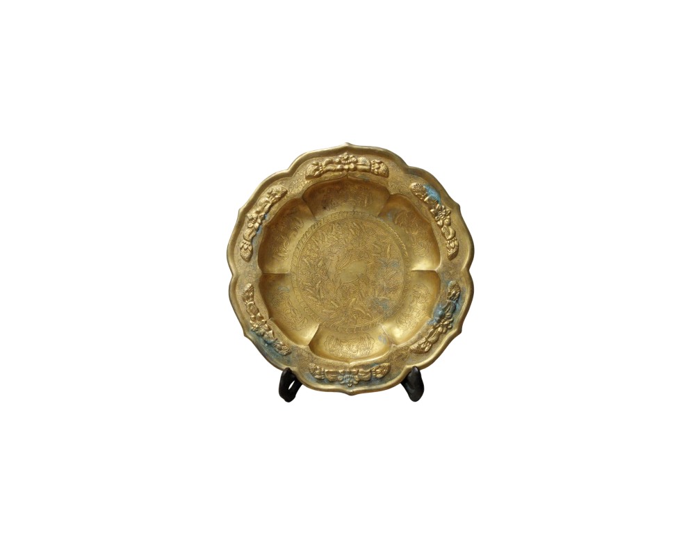 A gold-finished metal plate, characterised by a wavy outer profile and a rim decorated with prominent floral reliefs; available for hire for events, advertising, films and TV series
