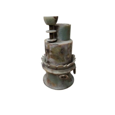 An ornamental and sculptural stone object with a marbled finish in greenish and earthy tones, giving it an antique appearance, characterised by a complex, multi-layered structure comprising cylindrical sections, overlapping rings, linear engravings and subtle markings on its surface; available for hire for events, advertising, films and TV series