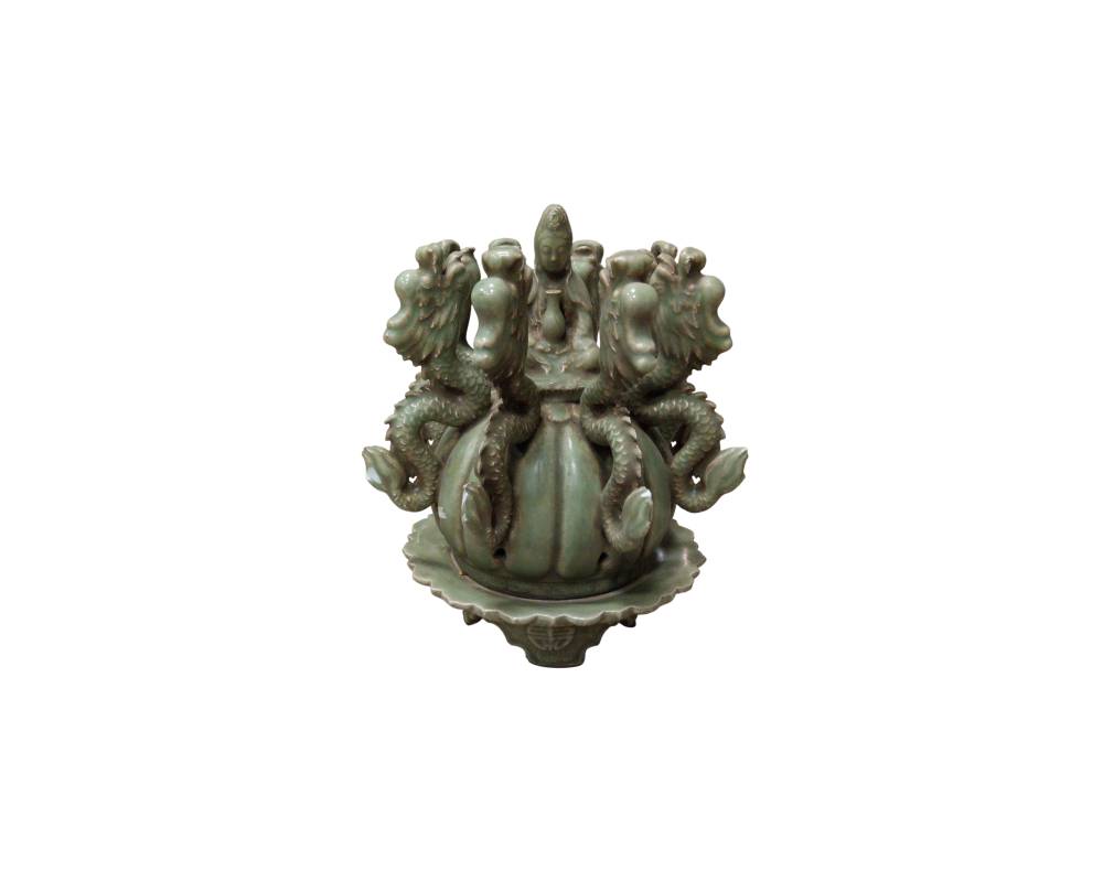 This piece is an elaborate ornamental ceramic sculpture with a glazed finish in celadon green tones, in a traditional style, available for hire for events, advertising, films and TV series
