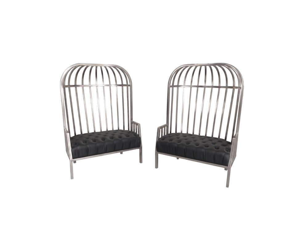 It is characterised by a tall metal frame that resembles the bars of a cage and a dark-coloured upholstered seat featuring a tufted finish, combining an industrial style with decorative elegance. Available for hire for events, advertising, films and TV series.