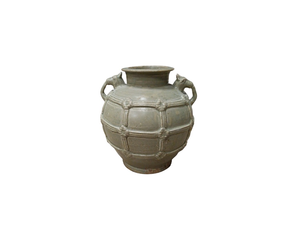 a ceramic jug or vase with a distinctive greenish or celadon glaze, characterised by a globular body adorned with a network of interlaced geometric reliefs, a wide neck and two side handles sculpted in the shapes of animals. Available for hire for events, advertising, films and TV series.