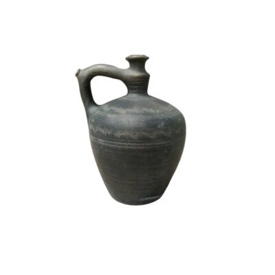 A ceramic jug in dark and grey tones, with a stylised globular body, a small opening at the top and a raised side handle that connects to the neck; available for hire for events, advertising, films and TV series