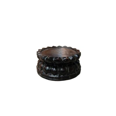 A circular pedestal carved from dark wood, shaped to resemble the petals of a lotus flower; available for hire for events, advertising, films and TV series