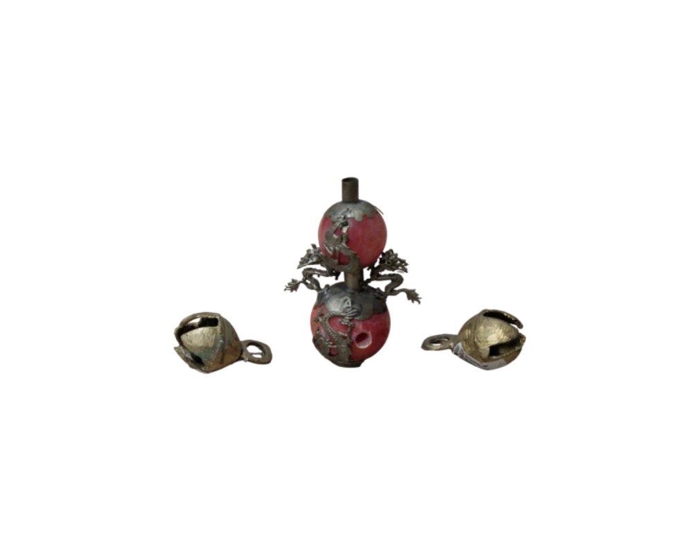 consisting of a vertical centrepiece comprising two reddish spherical sections decorated with metal appliqués featuring sculpted dragons and an upper neck, flanked on either side by two small open metal bells with rings; available for hire for events, advertising, films and TV series