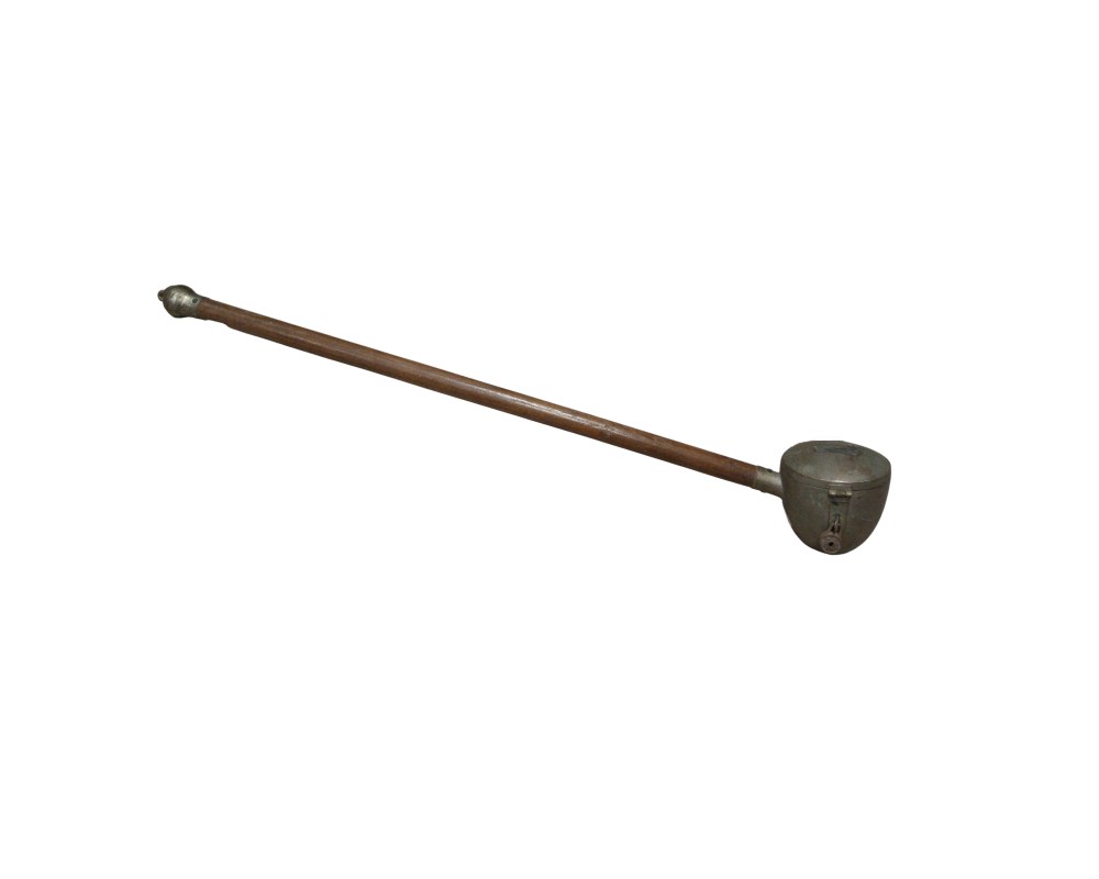 An elongated instrument consisting of a long wooden handle and a metal receptacle at one end. It features a slot at the top for inserting coins and a security mechanism with a padlock. Historically, this type of item was used to collect donations from a distance in religious institutions or venues, ensuring the contents remained secure until opened by the relevant authorities. Available for hire for events, advertising, films and TV series.