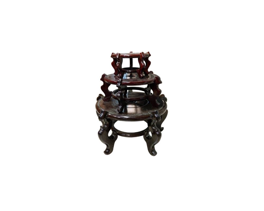 comprising multiple circular wooden bases or supports with a polished finish in dark brown tones, designed in different sizes to fit together or be stacked on top of one another; available for hire for events, advertising, films and TV series