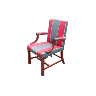 A sturdy wooden chair, characterised by its curved armrests and a robust structural design featuring crossbars connecting the legs. The seat and backrest are upholstered in a fabric with vertical stripes in shades of red and greyish blue, finished with decorative stud detailing. Available for hire for events, advertising, films and TV series.
