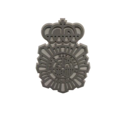 A die-cut or embossed reproduction of the official coat of arms of the Spanish National Police Force in shades of grey, characterised by its openwork geometric design featuring the eight-pointed star and the royal crown above it; available for hire for events, advertising, films and TV series