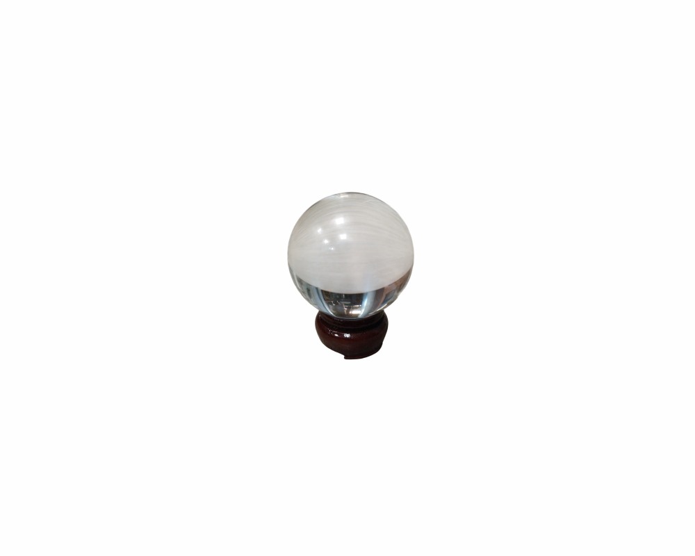 A decorative cut-glass sphere displaying interesting whitish veins or inclusions inside, presented on a small base; available for hire for events, advertising, films and TV series