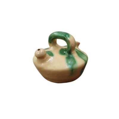 A traditionally designed ceramic jug, characterised by a bulbous base, an arched handle at the top, a spout and a light-coloured glazed finish with striking splashes; available for hire for events, advertising, films and TV series