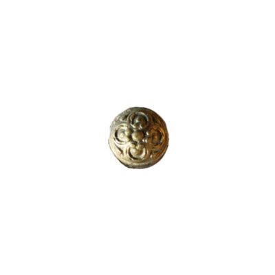 A vintage door knob, dating from around the 1950s and made from cast and embossed brass. It has a semi-spherical shape decorated with a detailed symmetrical geometric and floral ornamental motif in relief on its front surface, displaying a warm, aged patina. Available for hire for events, advertising, films and TV series.