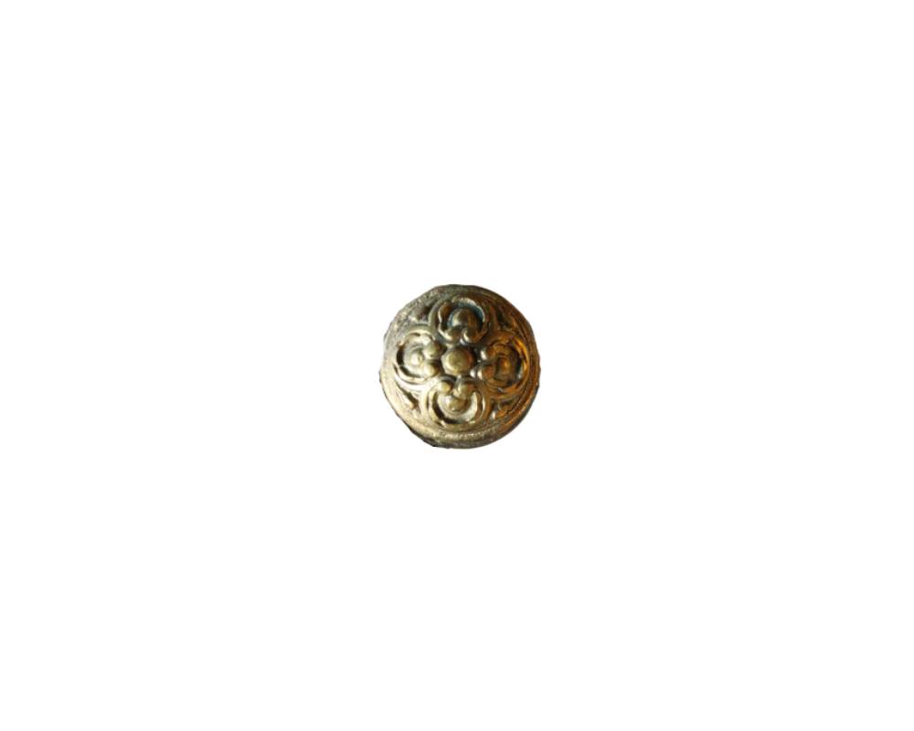 A vintage door knob, dating from around the 1950s and made from cast and embossed brass. It has a semi-spherical shape decorated with a detailed symmetrical geometric and floral ornamental motif in relief on its front surface, displaying a warm, aged patina. Available for hire for events, advertising, films and TV series.